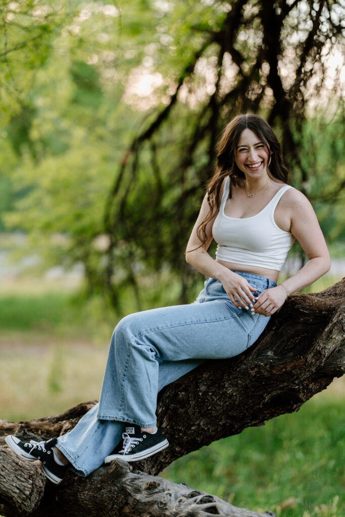 Senior photo session in the green grass and trees at Butcher Jones Recreation Site, Salt River, Mesa, Arizona.