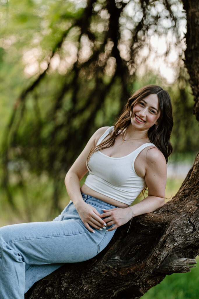 Senior photo session in the green grass and trees at Butcher Jones Recreation Site, Salt River, Mesa, Arizona.